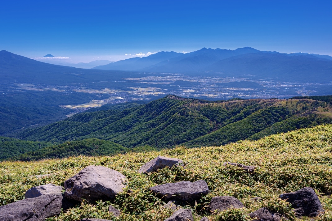 Scenic view of the Yatsugatake Mountains with volcanic peaks and alpine forests, ideal for hiking and Campervan Road trip with Travellers Autobarn in Yatsugatake-Chūshin Kōgen, Japan