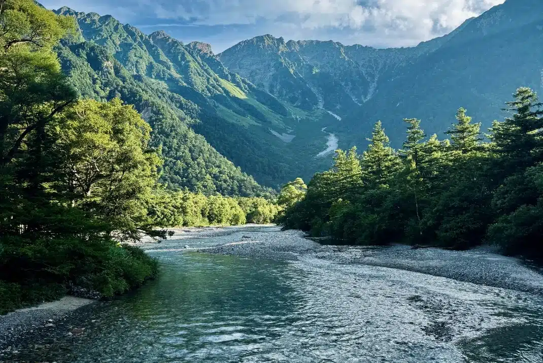 Clear Azusa River flowing through pristine mountain alpine landscape in Kamikochi Japan